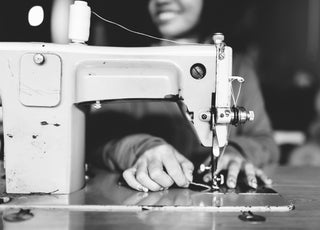 Outland denim seamstress at sewing machine