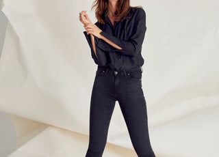 Woman in studio wearing the Harriet jean in Black outland denim