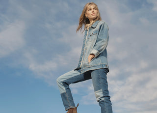 Woman in front of blue sky wearing double denim
